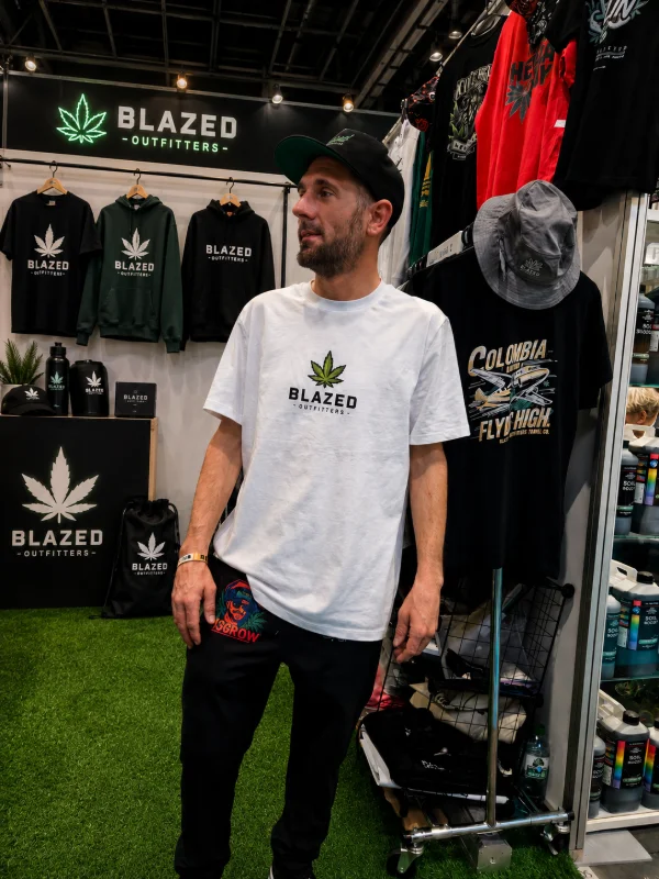 Blazed Outfitters auf der Messe 🔥 Ein sauberer, professioneller Messestand mit klarem Fokus auf die Marke. Die störenden Hintergrundelemente wurden entfernt und durch authentische Blazed Outfitters Produkte ersetzt. Kräftigere Farben, verbesserte Schärfe und ein moderner Streetwear-Look sorgen für einen hochwertigen Auftritt. Der Fokus liegt jetzt komplett auf der Brand, den Designs und der einzigartigen Blazed Outfitters Atmosphäre – genau die Mischung aus Lifestyle, Community und kreativem Ausdruck, für die Blazed Outfitters steht. 🌿👕✨